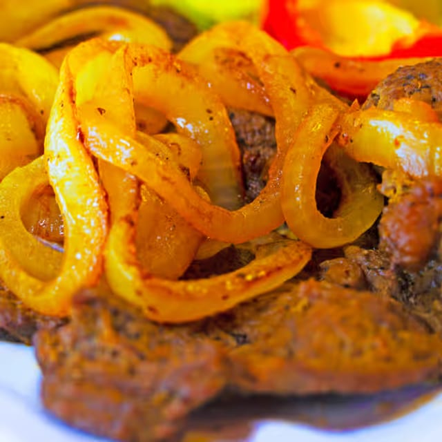 Bistec Encebollado - Steak With Onions.